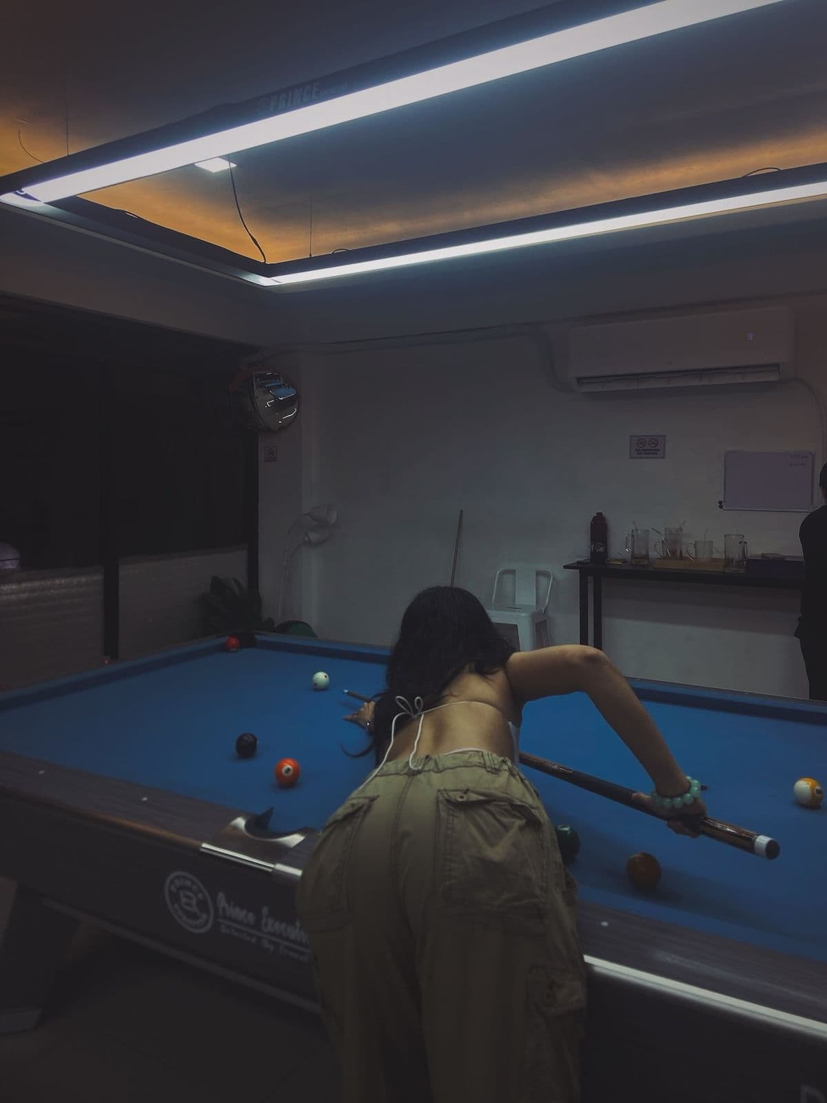 Close-up of billiards cue and balls on green felt