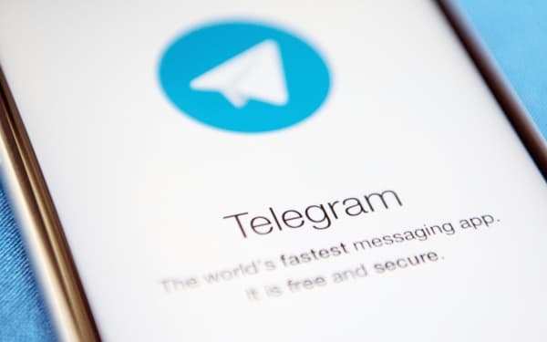 Close-up of a smartphone screen displaying the Telegram app logo and description